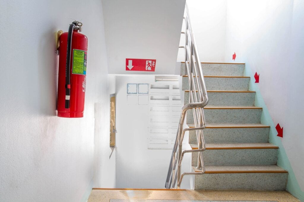 Stairwell with fire extinguisher and exit sign used in Adair evacuation training NSW